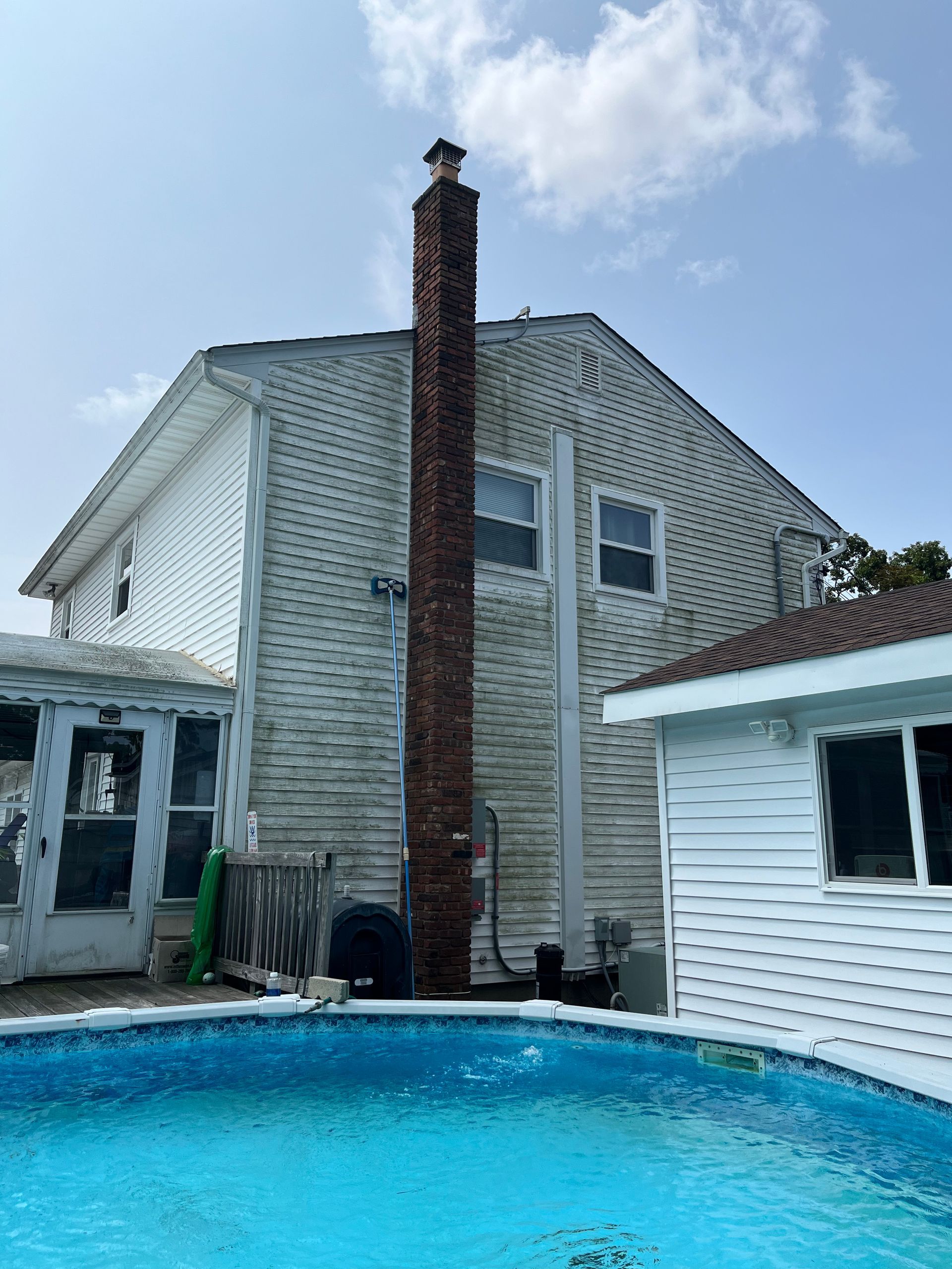 A large house with a swimming pool in front of it.