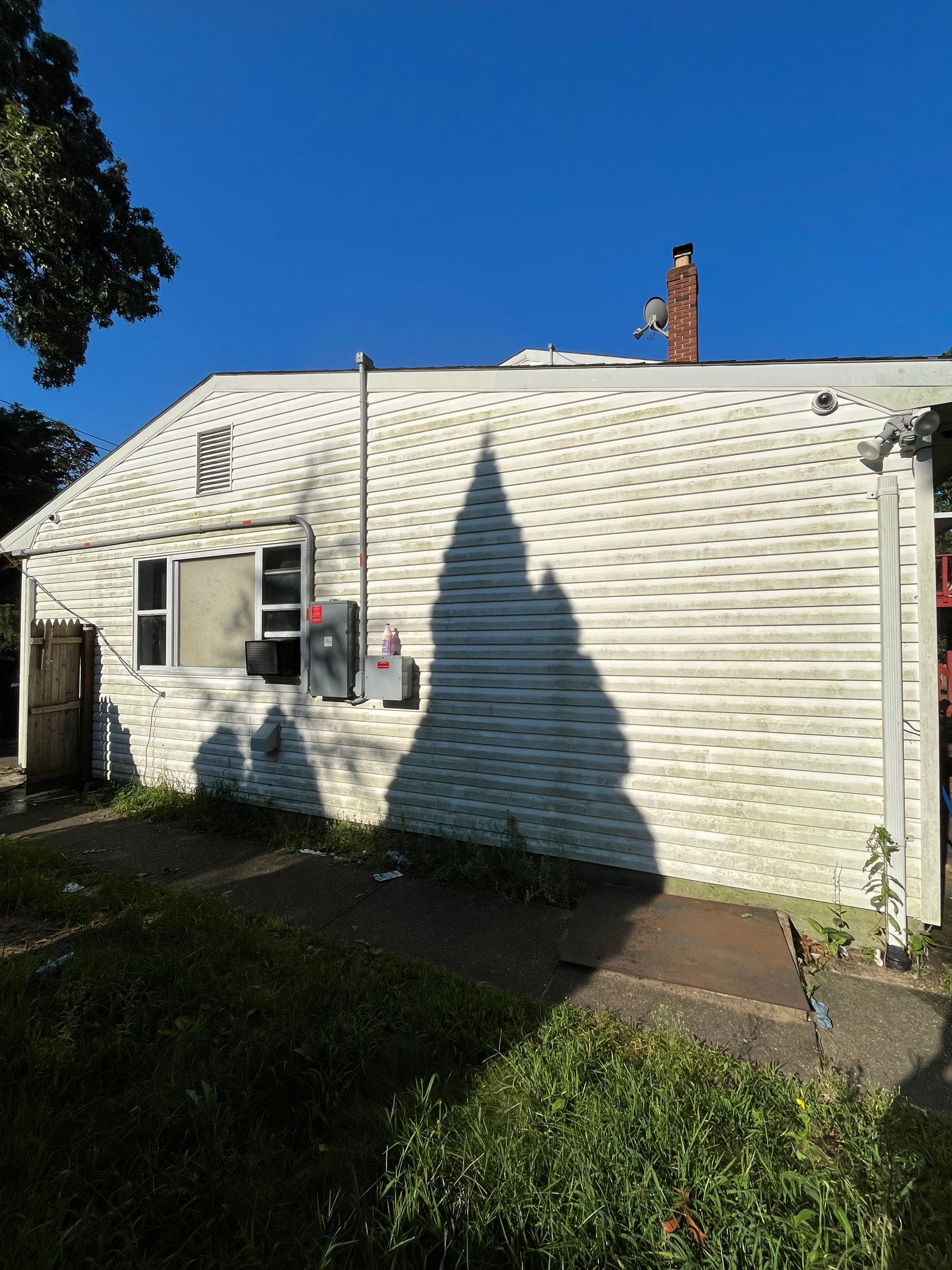 A white house with a chimney on top of it