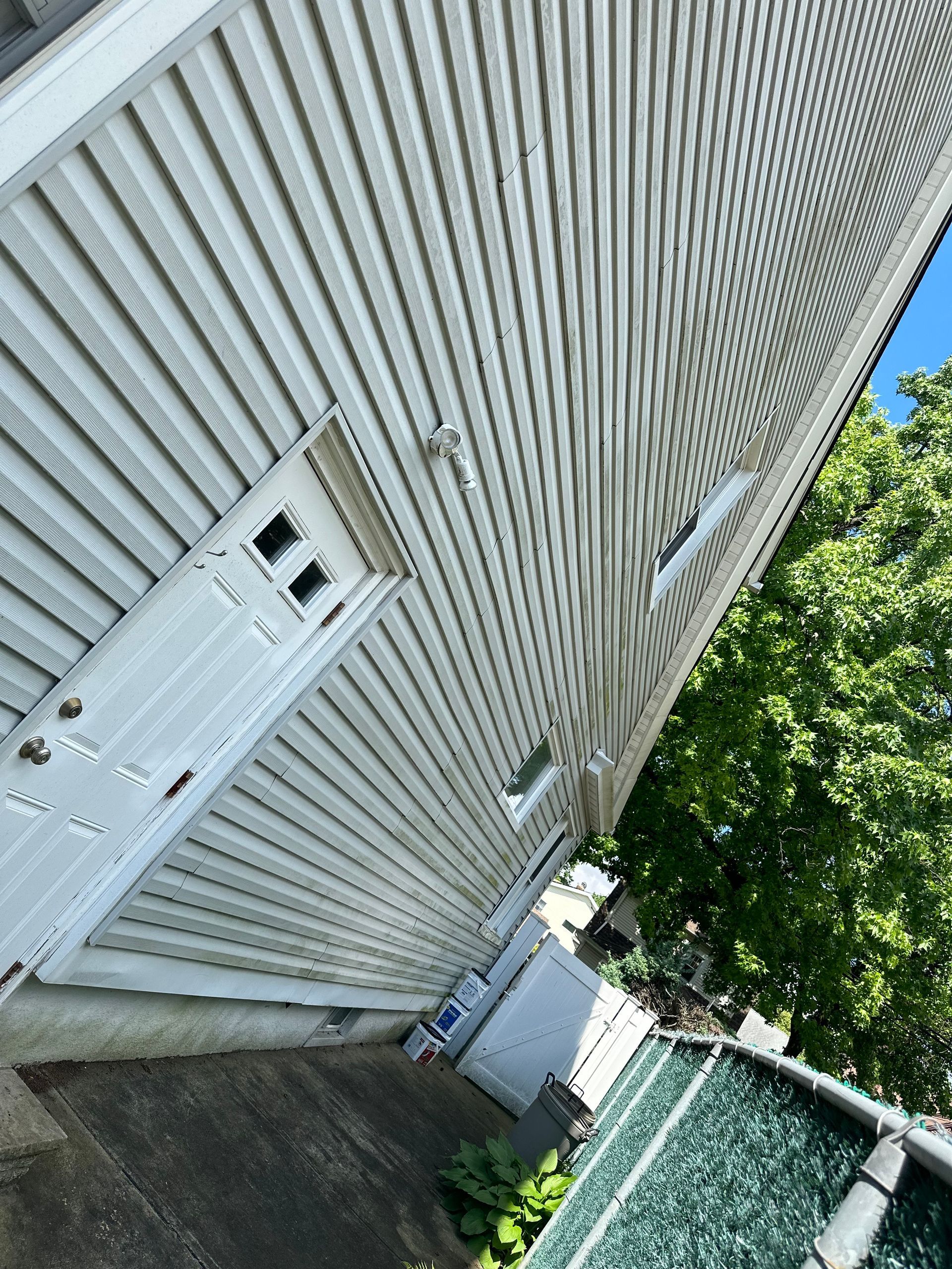 A white house with a white door and a white siding.