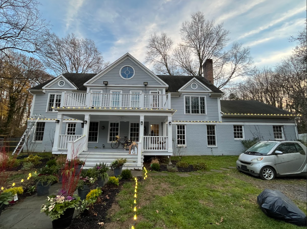 A large house with a car parked in front of it.