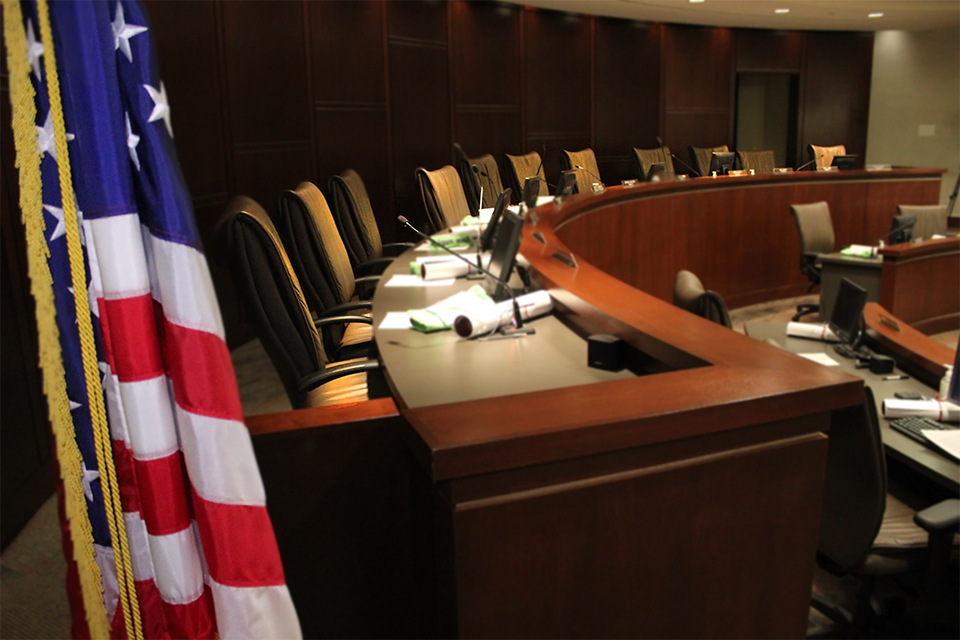 An empty conference room with an american flag in the foreground