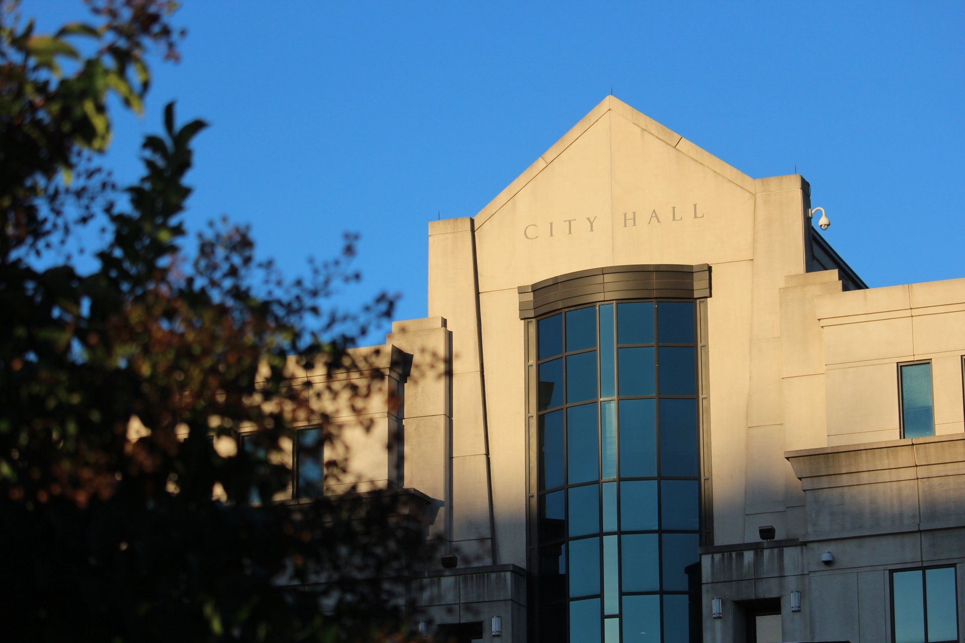 A large building with the word city hall on it