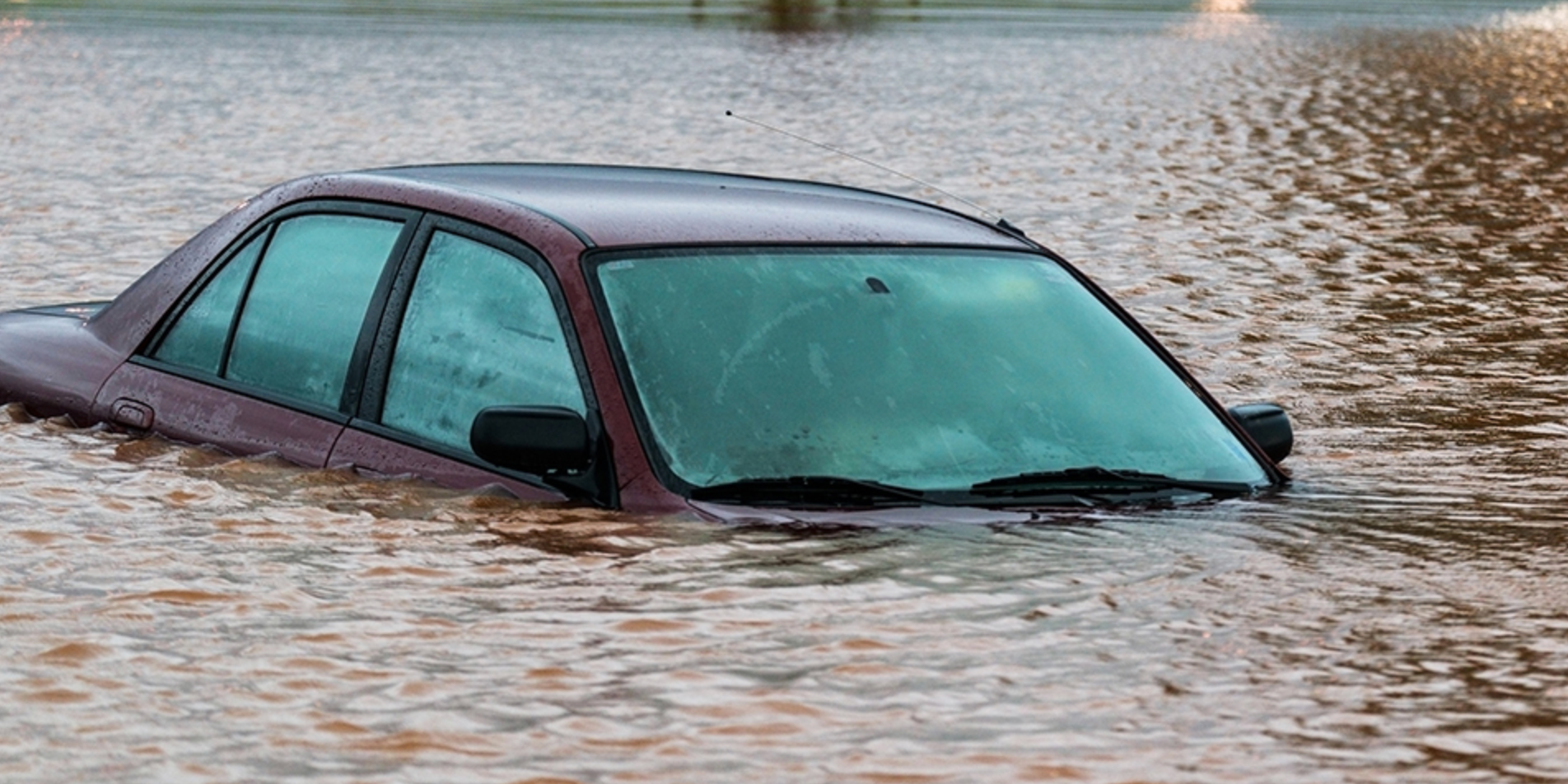 A car is stuck in a flooded area.