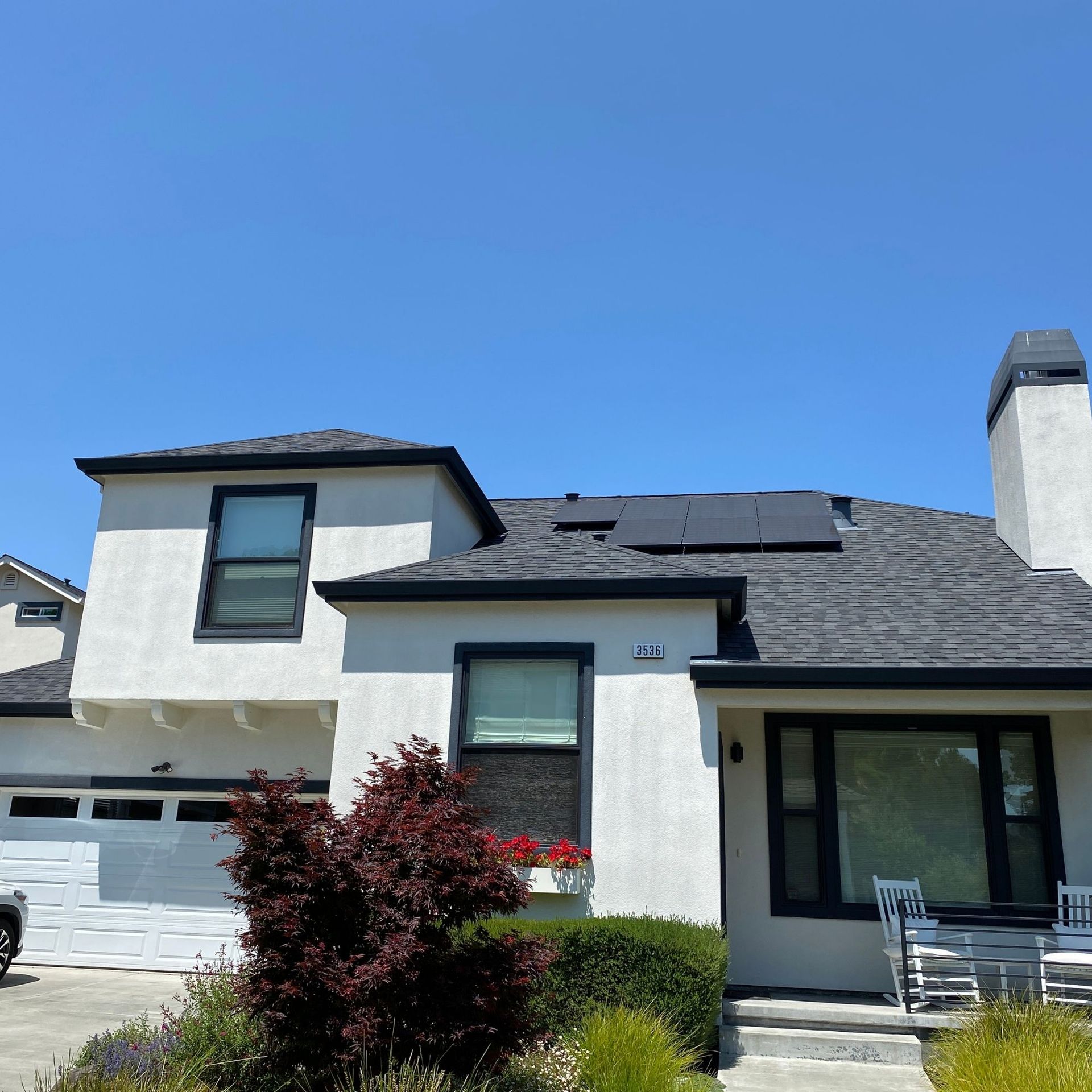 The Electric Pro - A white house with solar panels on the roof