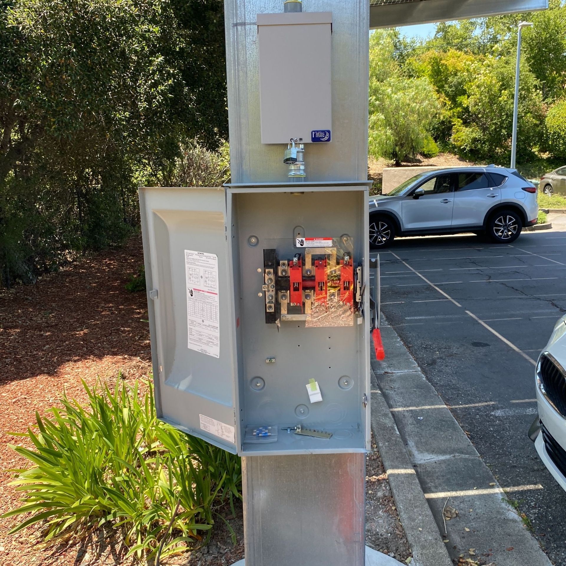 The Electric Pro - A car is parked in a parking lot next to a power box