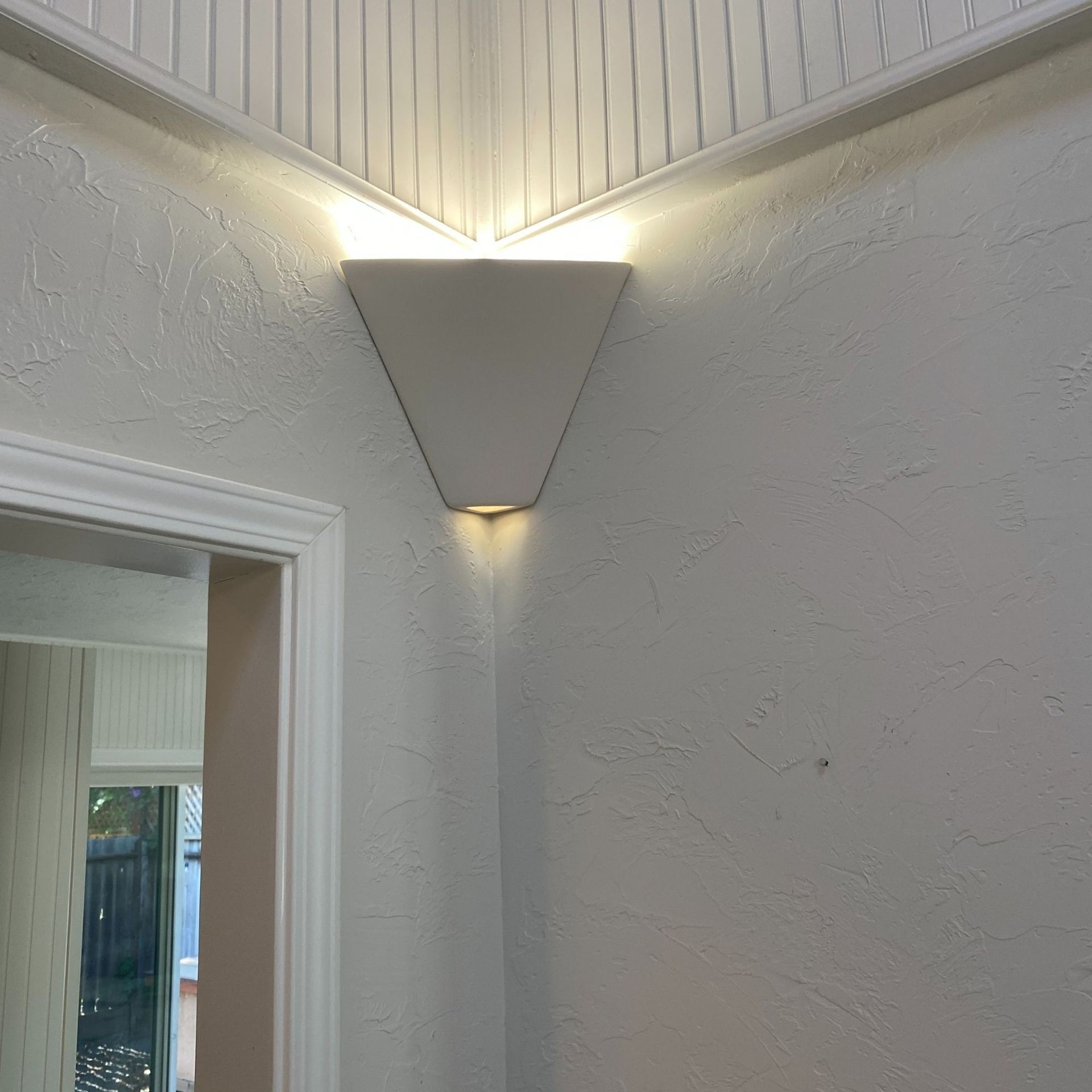 The Electric Pro - A white wall with a light on the corner of it