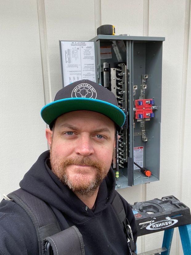 Local electrician from The Electric Pro standing beside branded service vehicle in Santa Rosa, CA
