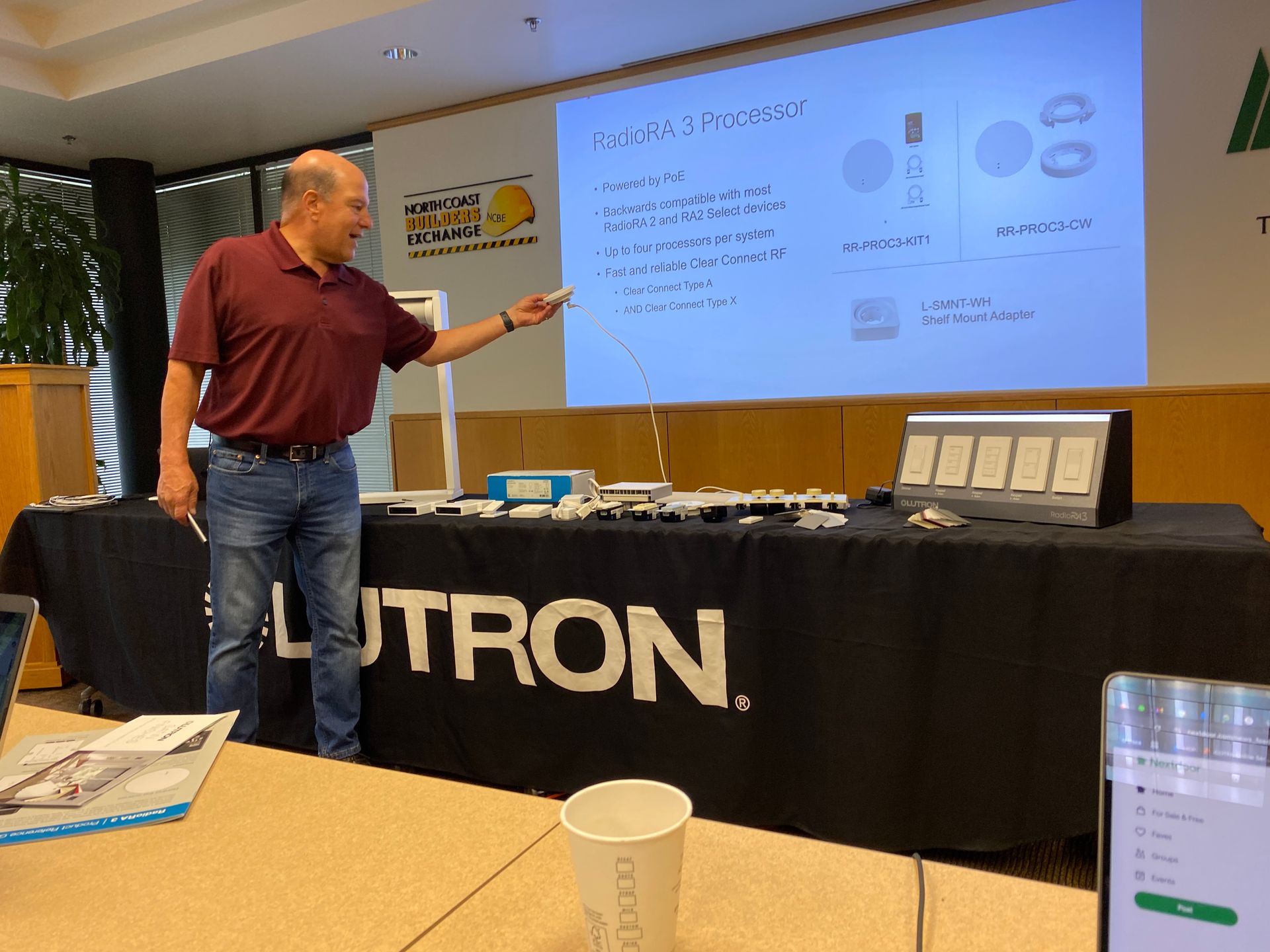 The Electric Pro - A man is giving a presentation in front of a lutron table