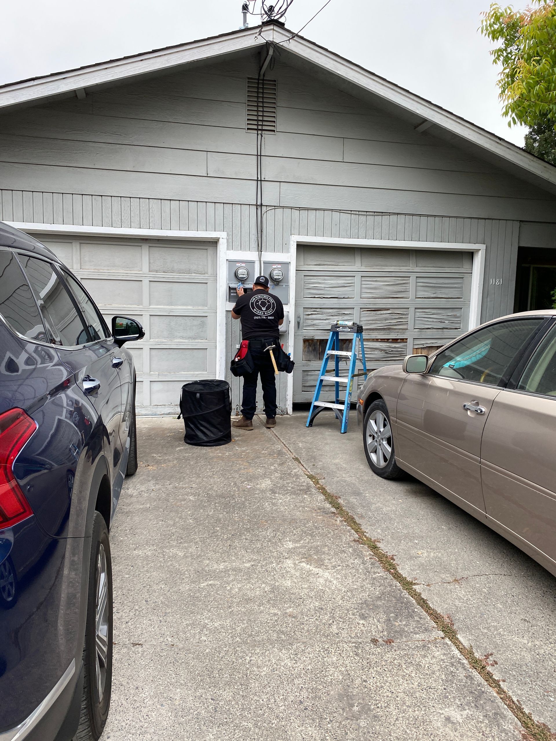 The Electric Pro - A man is standing in front of a garage door.