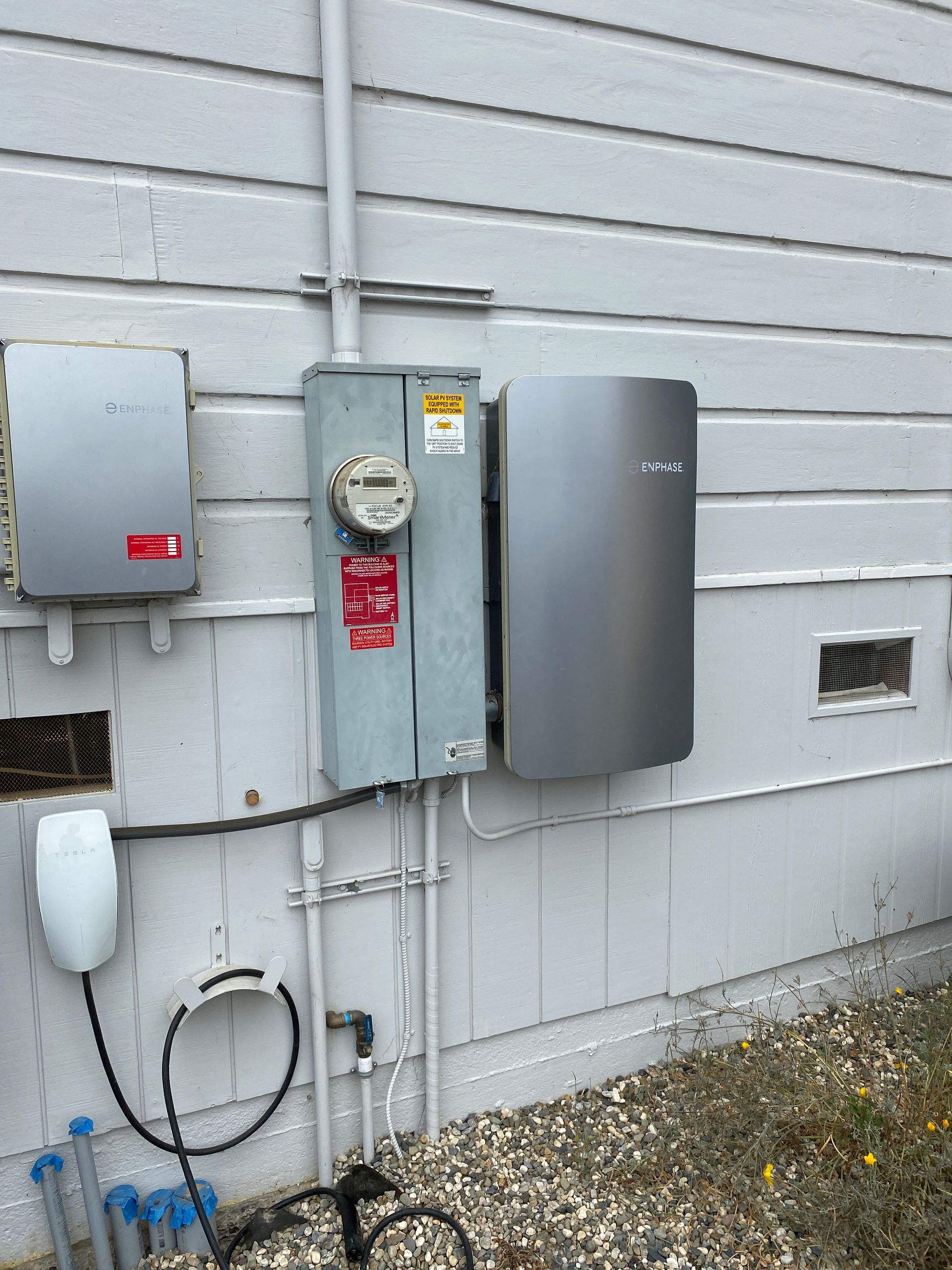 The Electric Pro - A solar panel is installed on the side of a house.