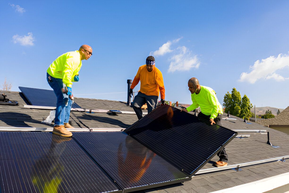 The Electric Pro - Installation team placing solar battery panels on a residential roof for off-grid solar system