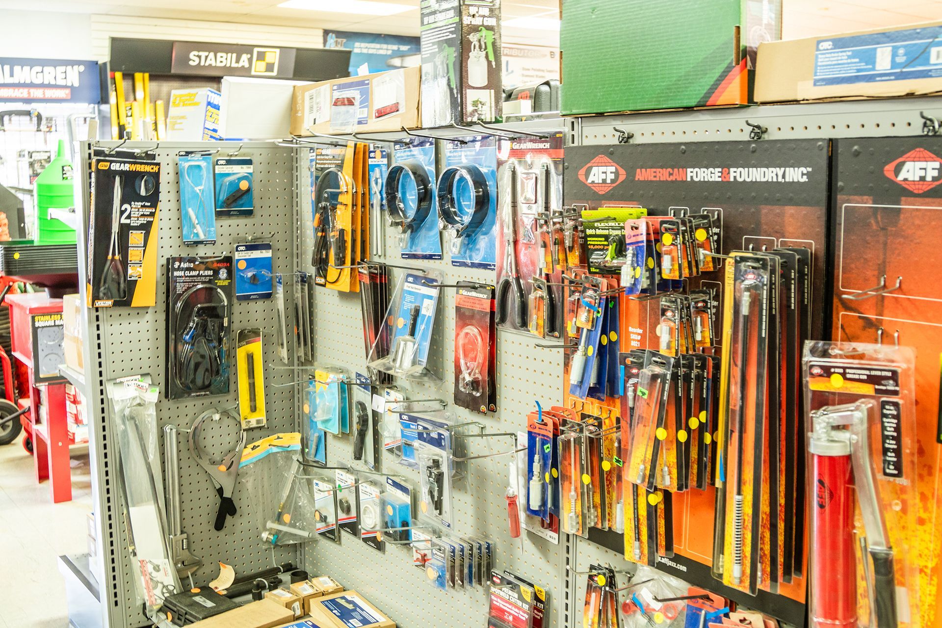 A variety of tools are displayed on a shelf in a store.