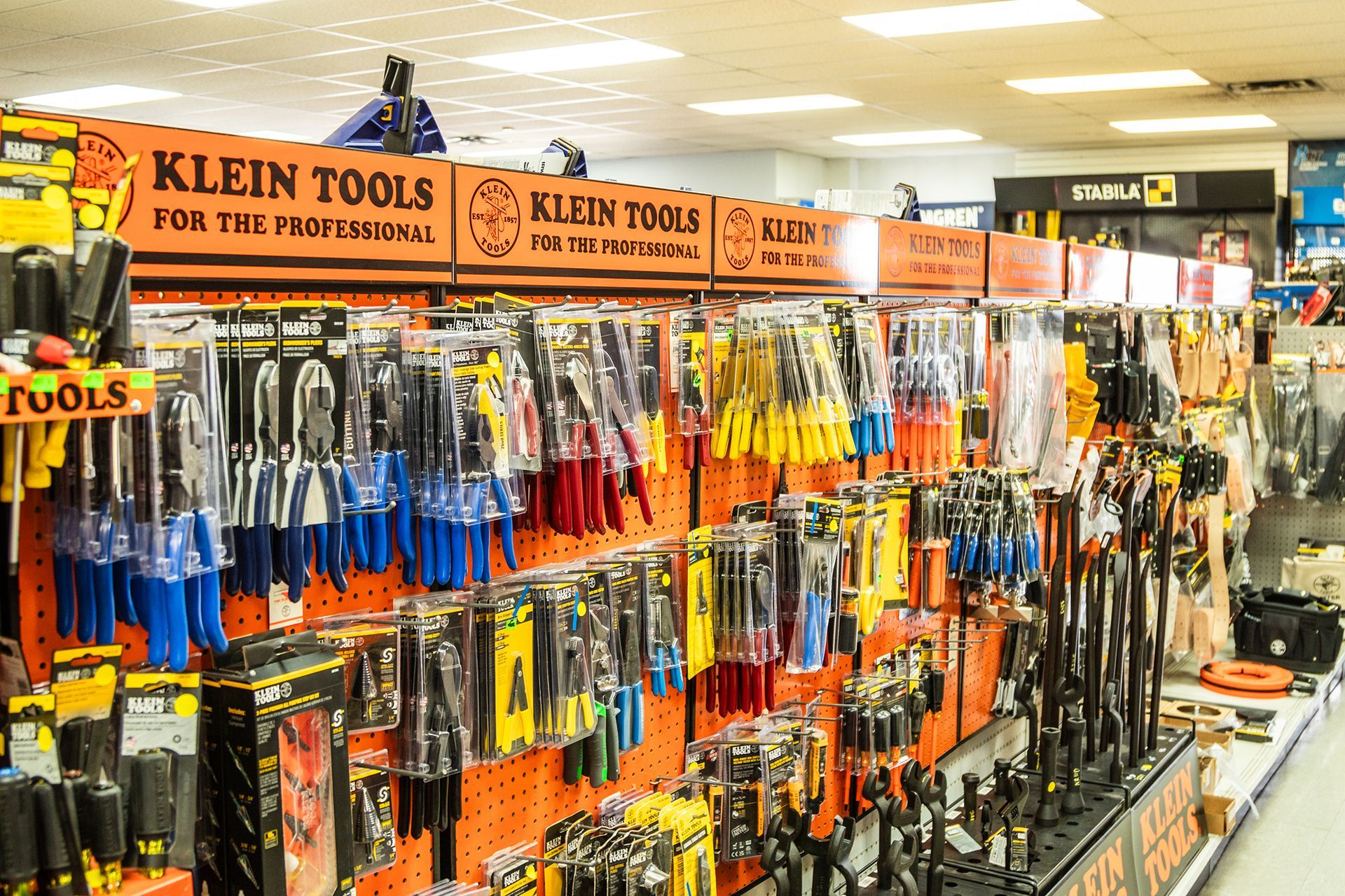 A bunch of tools are displayed on a shelf in a store.