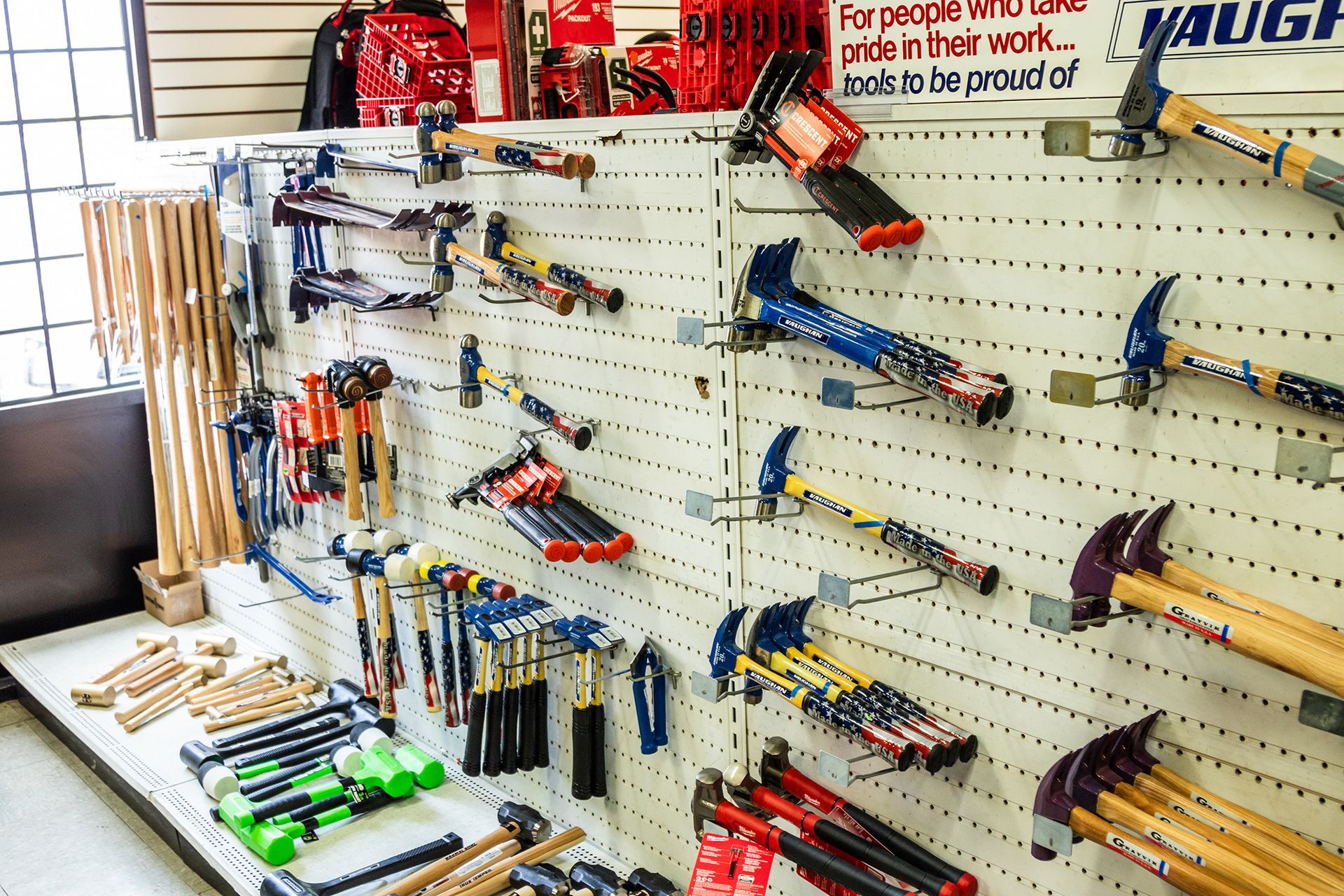 A bunch of tools are hanging on a wall in a store