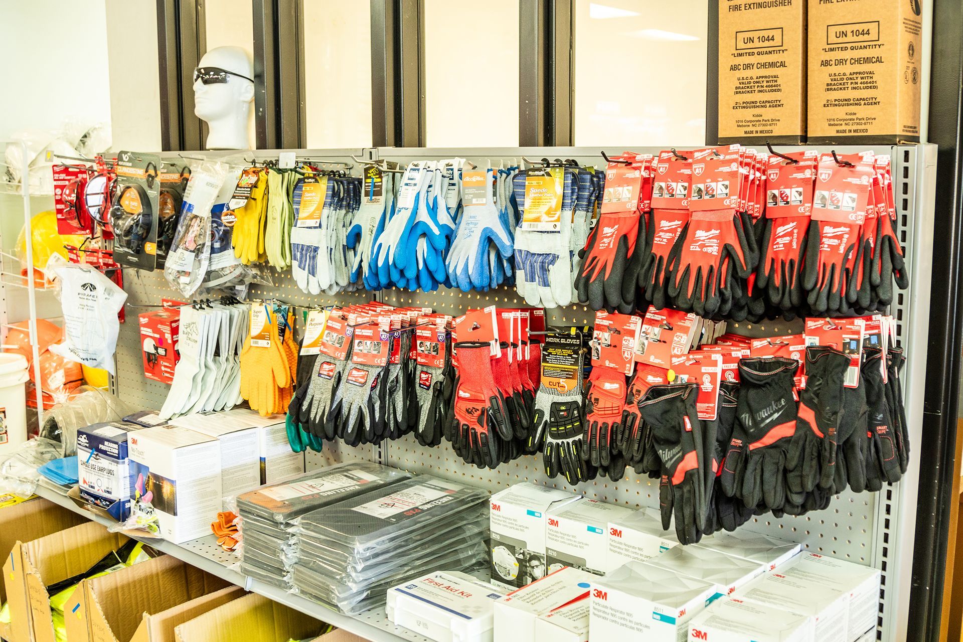 A shelf filled with lots of gloves and socks in a store.
