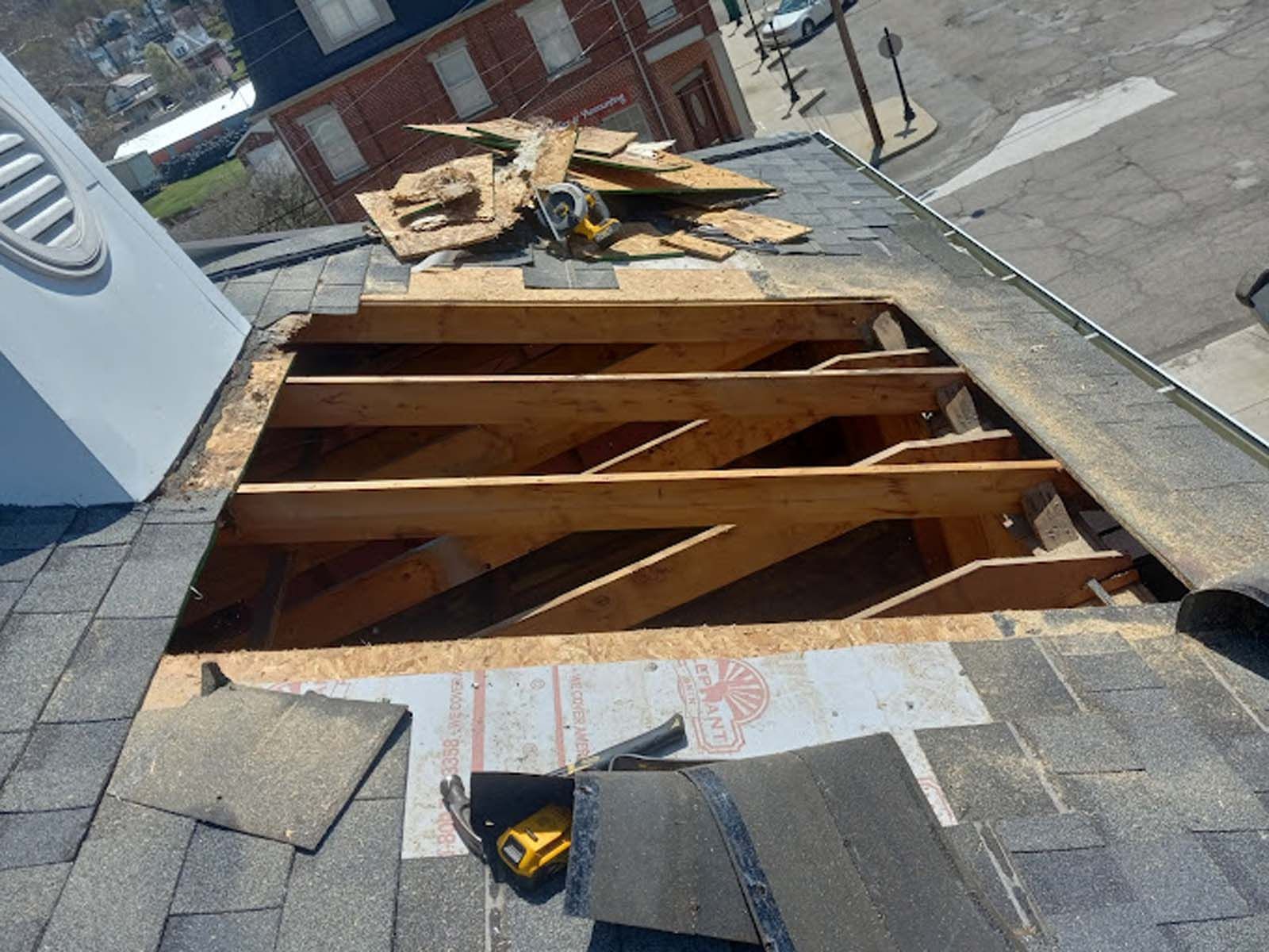 A roof with a hole in it is being repaired.