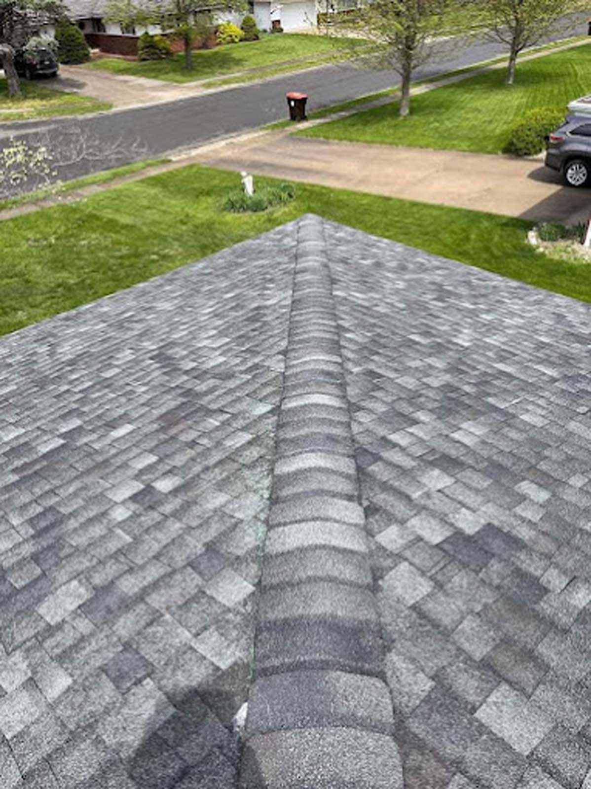 A roof with a lot of shingles on it in a residential area.