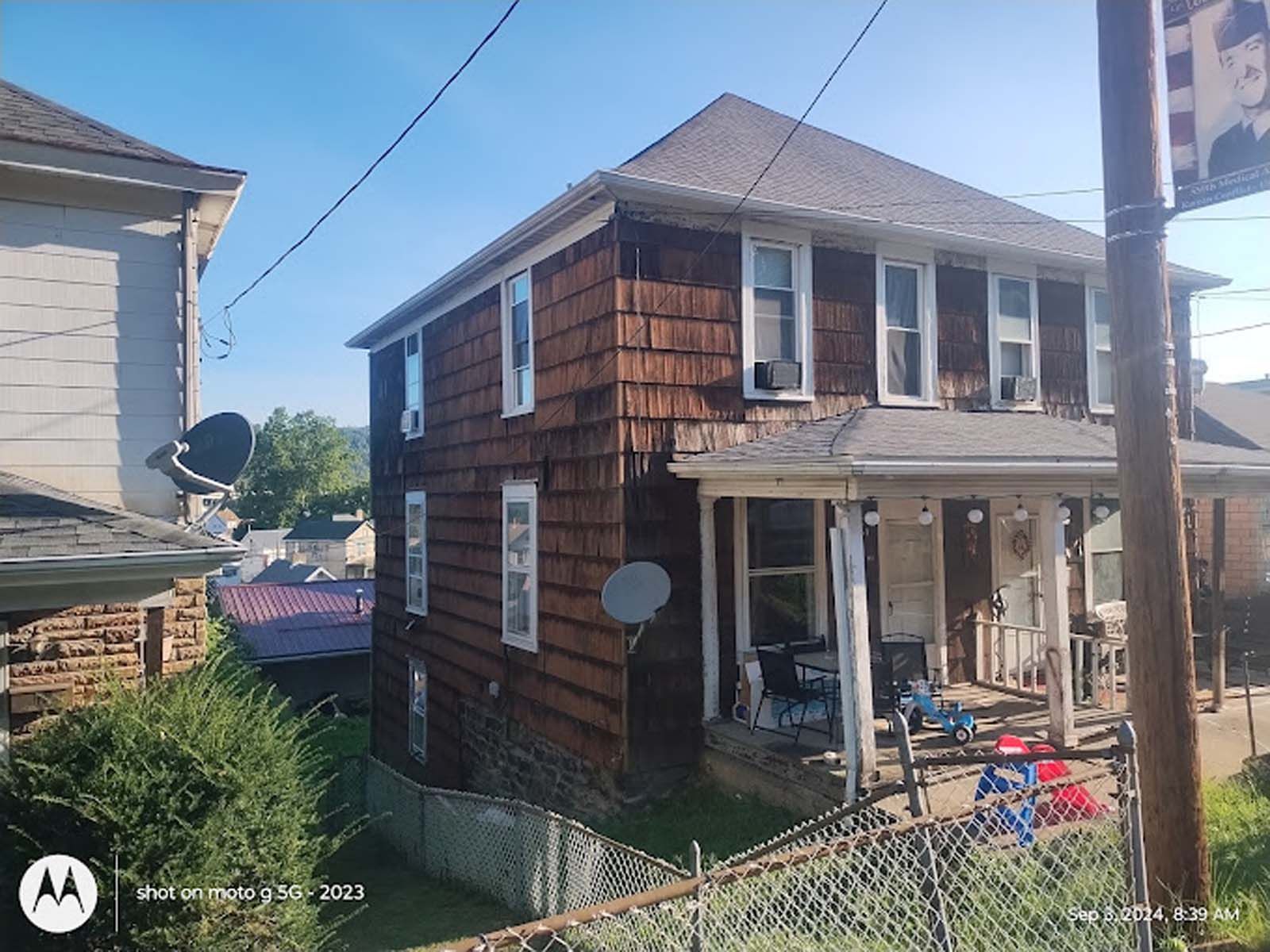 A house with a satellite dish on the side of it.