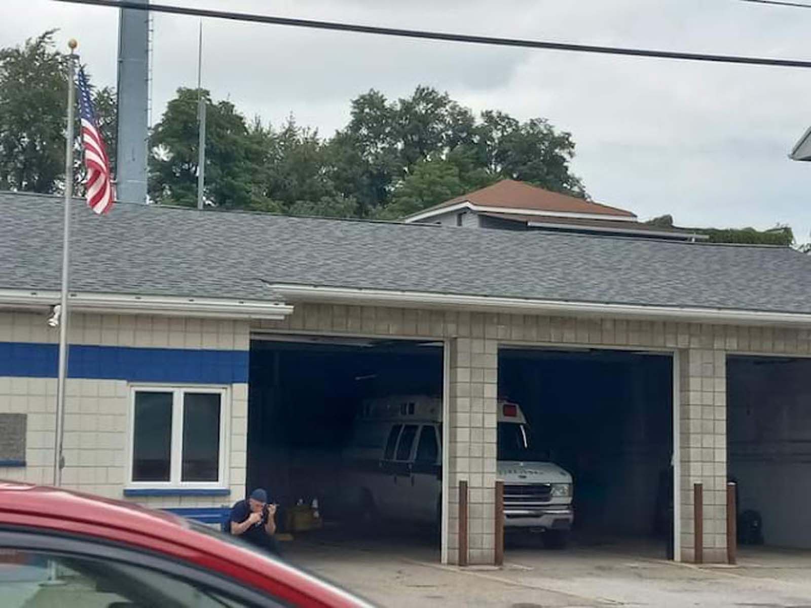 An ambulance is parked in the garage of a building