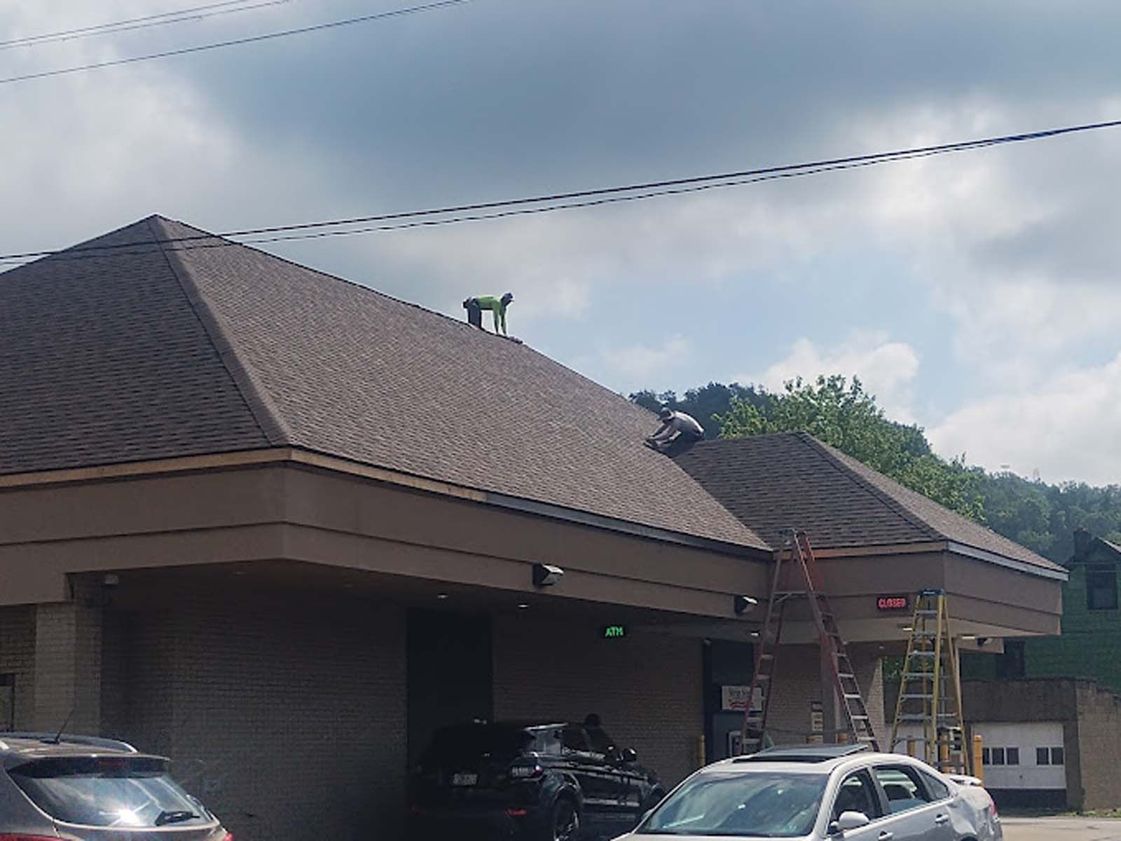 A dog is standing on the roof of a building