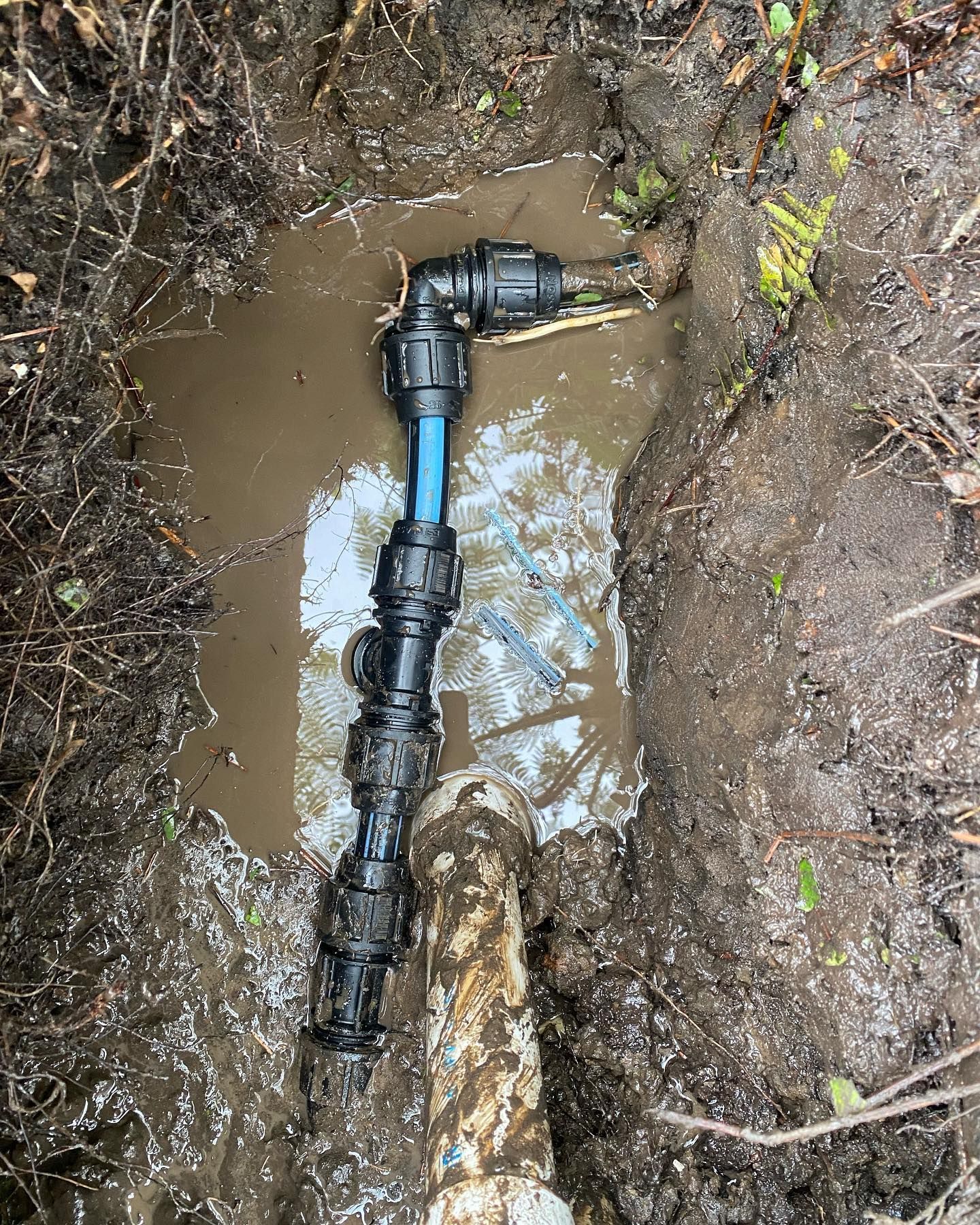 Black Pipe Fittings and Blue Pipe Section — C’s Plumbing & Gas Gold Coast in Yatala, QLD