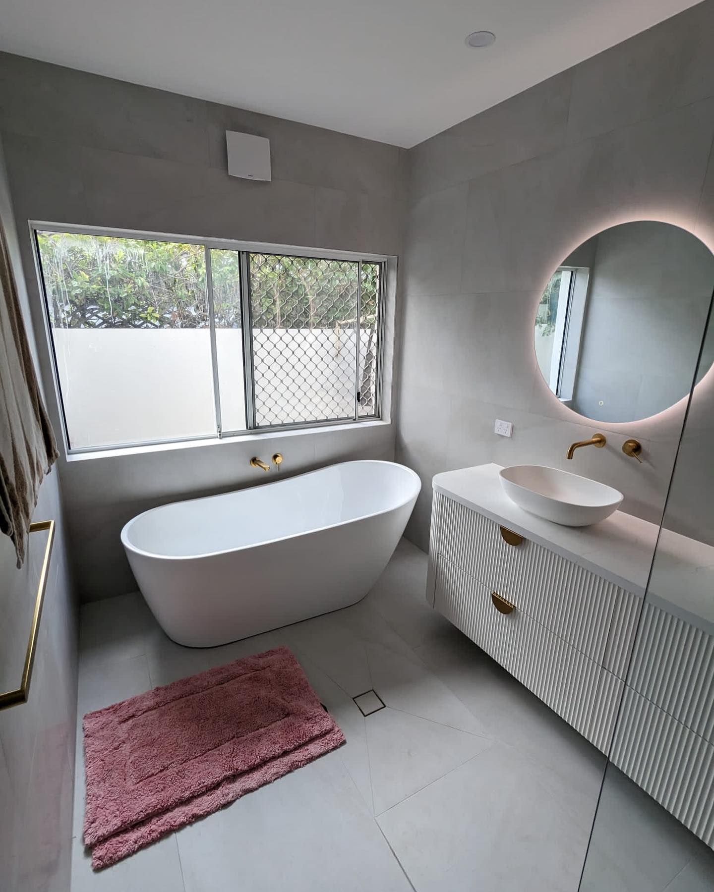 Modern Bathroom With Freestanding Tub, Vanity, and a Round Mirror — C’s Plumbing & Gas Gold Coast in Yatala, QLD