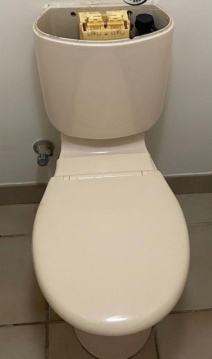 Tan Toilet With the Tank Lid Removed, in a Bathroom Setting — C’s Plumbing & Gas Gold Coast in Yatala, QLD