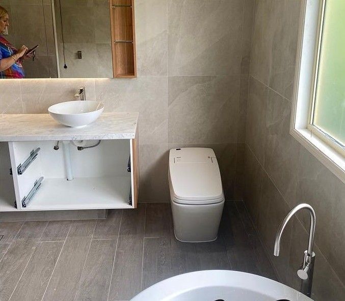 Modern Bathroom With a Floating Vanity, Smart Toilet — C’s Plumbing & Gas Gold Coast in Logan, QLD
