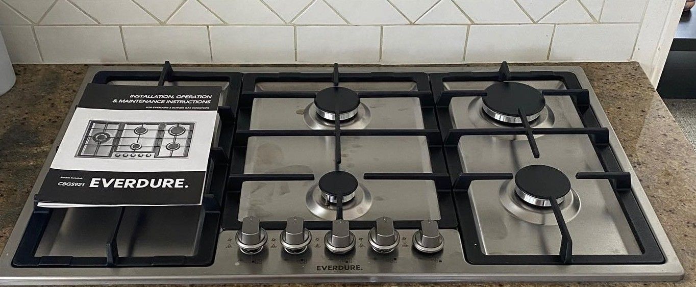 Stainless Steel Gas Cooktop With Five Burners — C’s Plumbing & Gas Gold Coast in Yatala, QLD