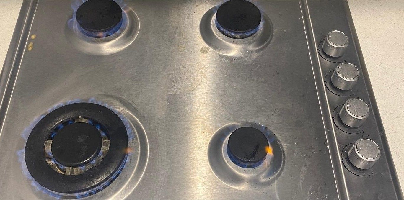 Gas Stovetop With Four Burners Lit, Blue Flames Visible — C’s Plumbing & Gas Gold Coast in Yatala, QLD
