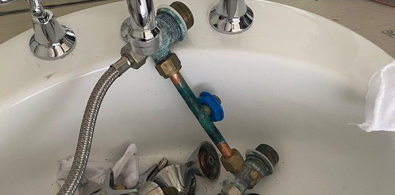 Disassembled Bathroom Faucet in a White Sink — C’s Plumbing & Gas Gold Coast in Ipswich, QLD