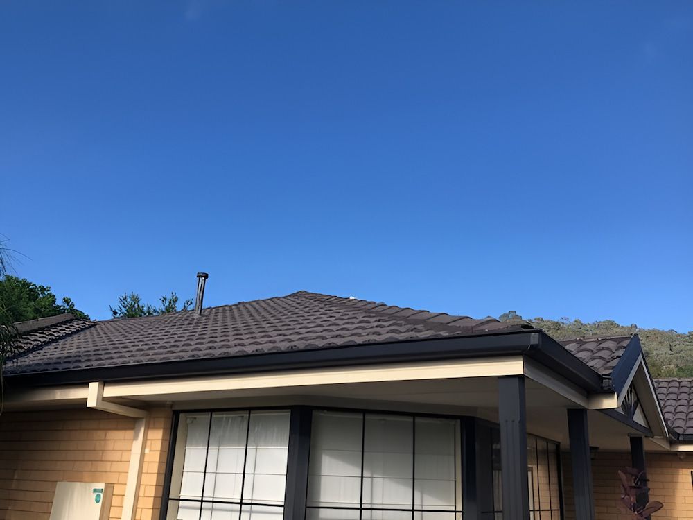 A House With a Roof and a Blue Sky in the Background — Recoat Painting In West Wodonga, VIC