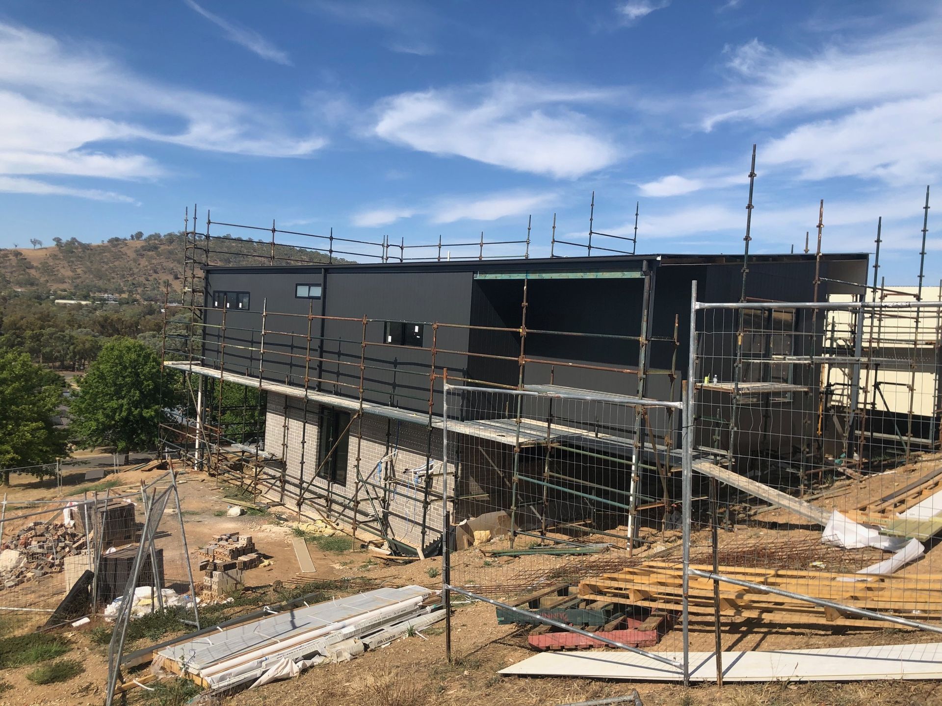 A large building under construction with scaffolding around it — Recoat Painting In West Wodonga, VIC