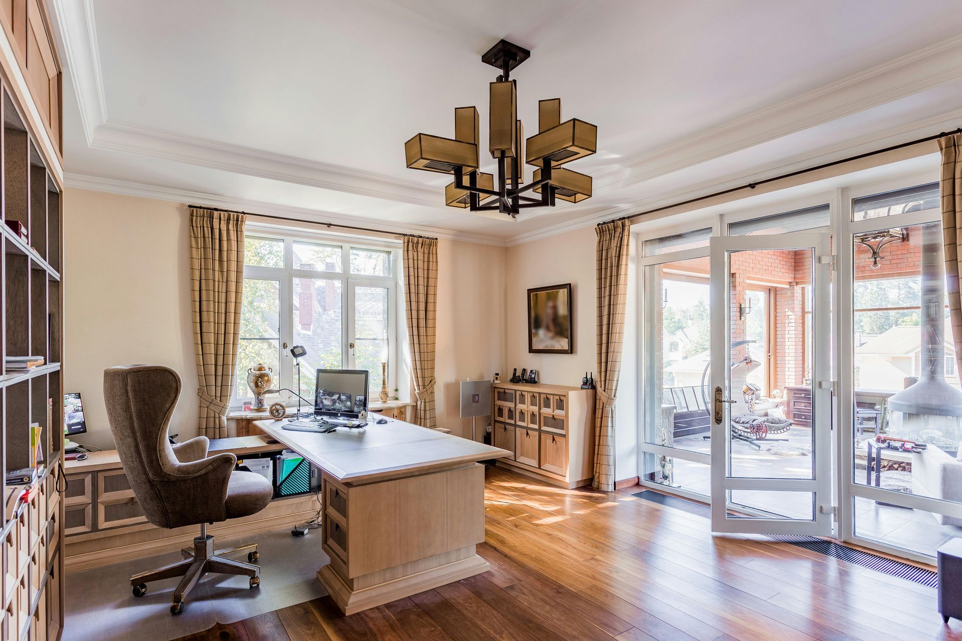 Bright home office with wooden desk, chair, large windows, and French doors opening to a patio. Recoat Painting In West Wodonga, VIC