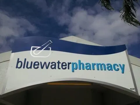 A Blue Water Pharmacy Sign With a Blue Sky in the Background — Bluewater Pharmacy in Yabulu, QLD