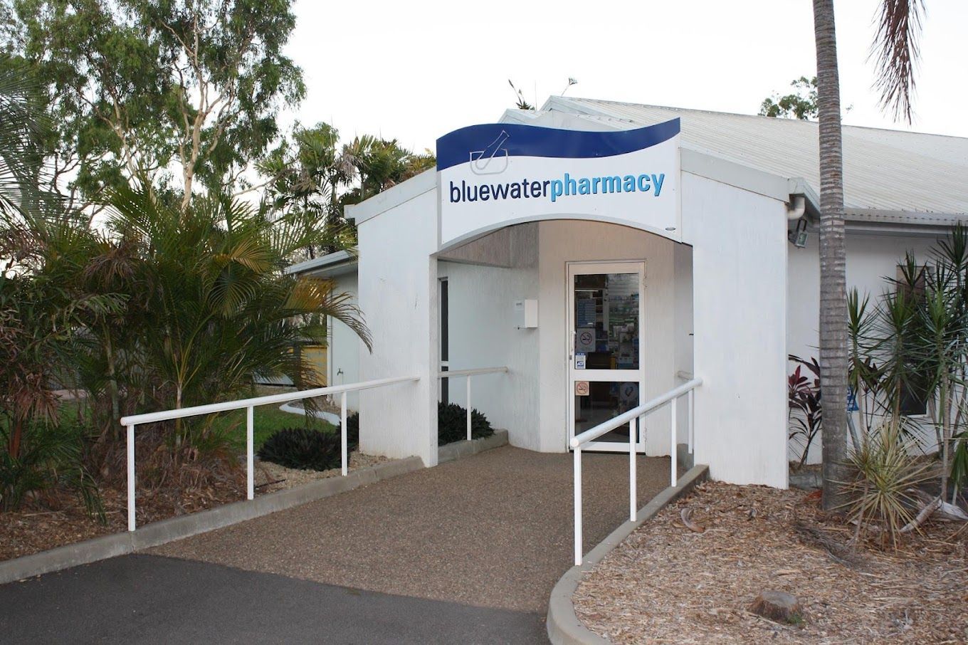 A Sign for Bluewater Pharmacy is in the Middle of a Grassy Field — Bluewater Pharmacy in Yabulu, QLD