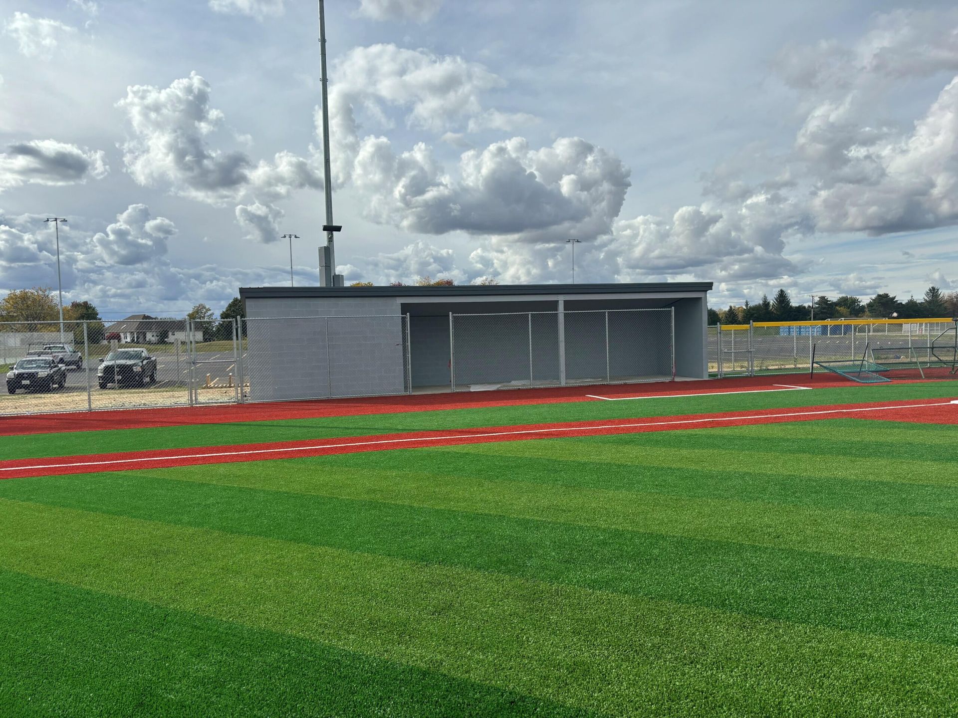 A baseball field with a dugout in the middle of it.