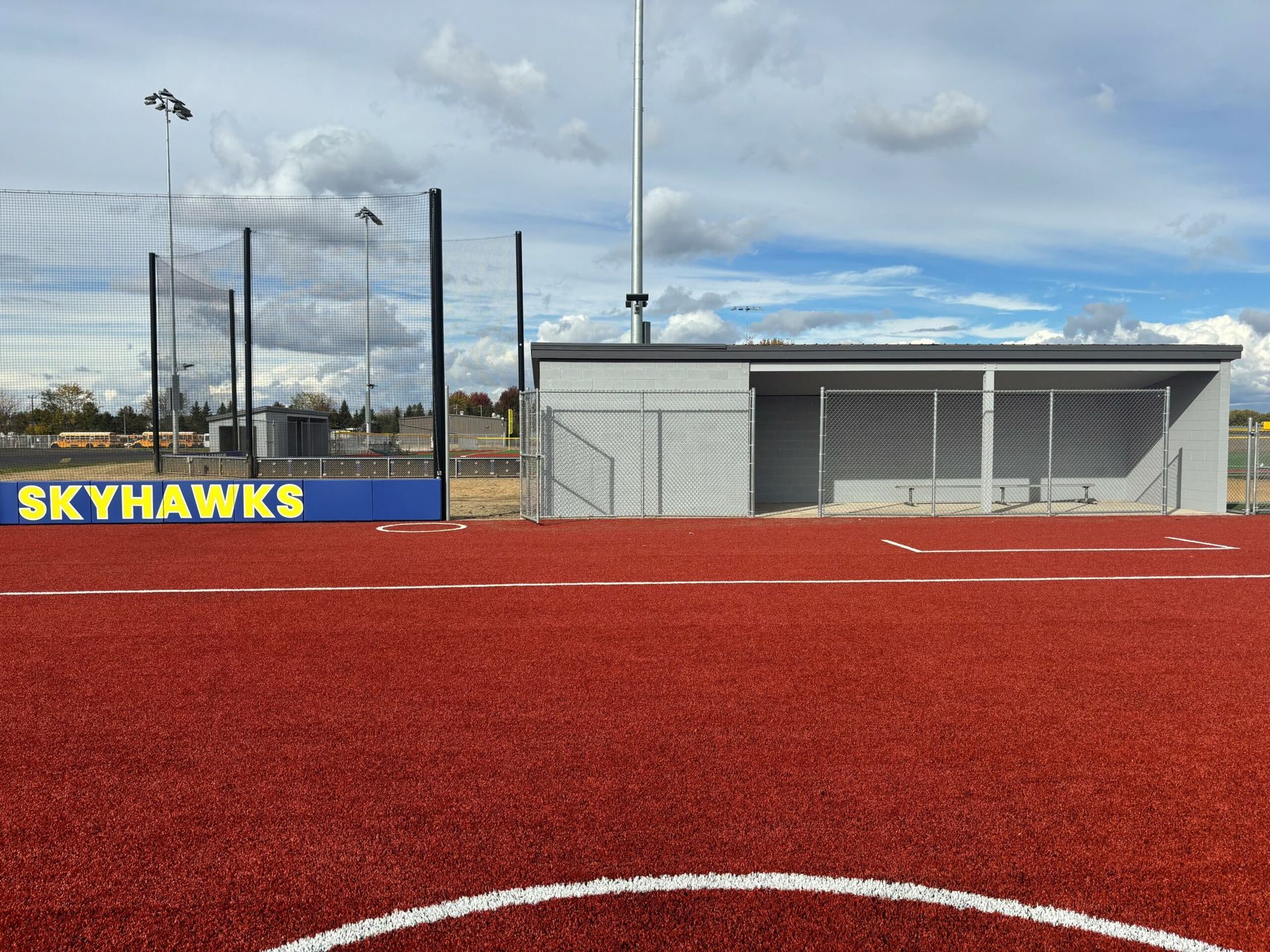 A baseball field with a sign that says skyhawks