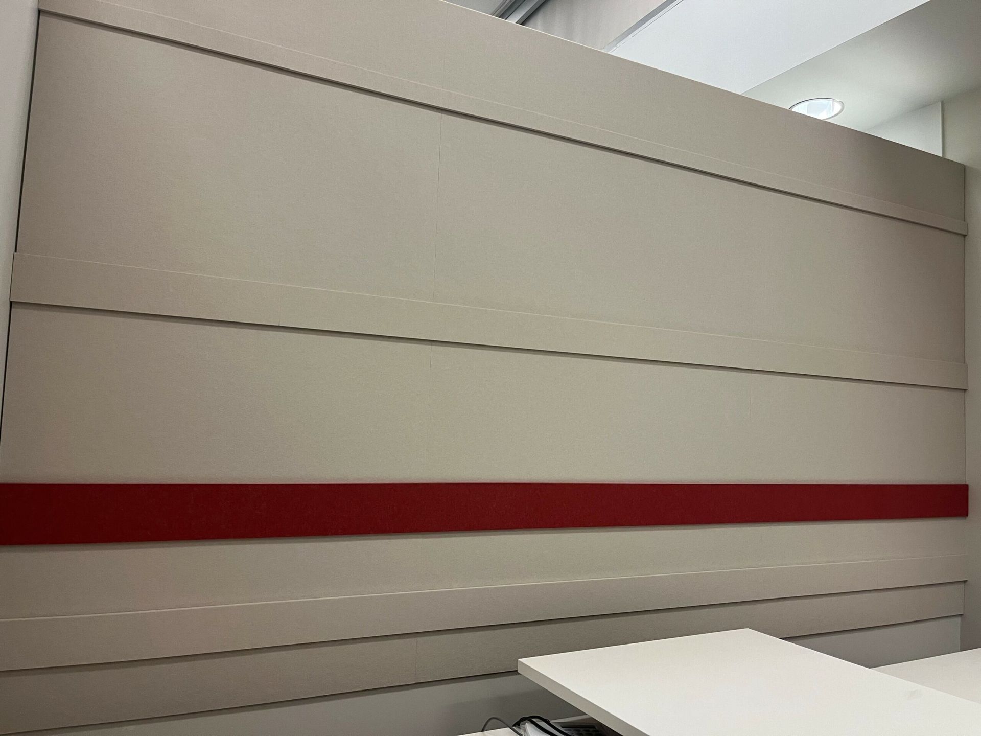 A white wall with a red stripe on it