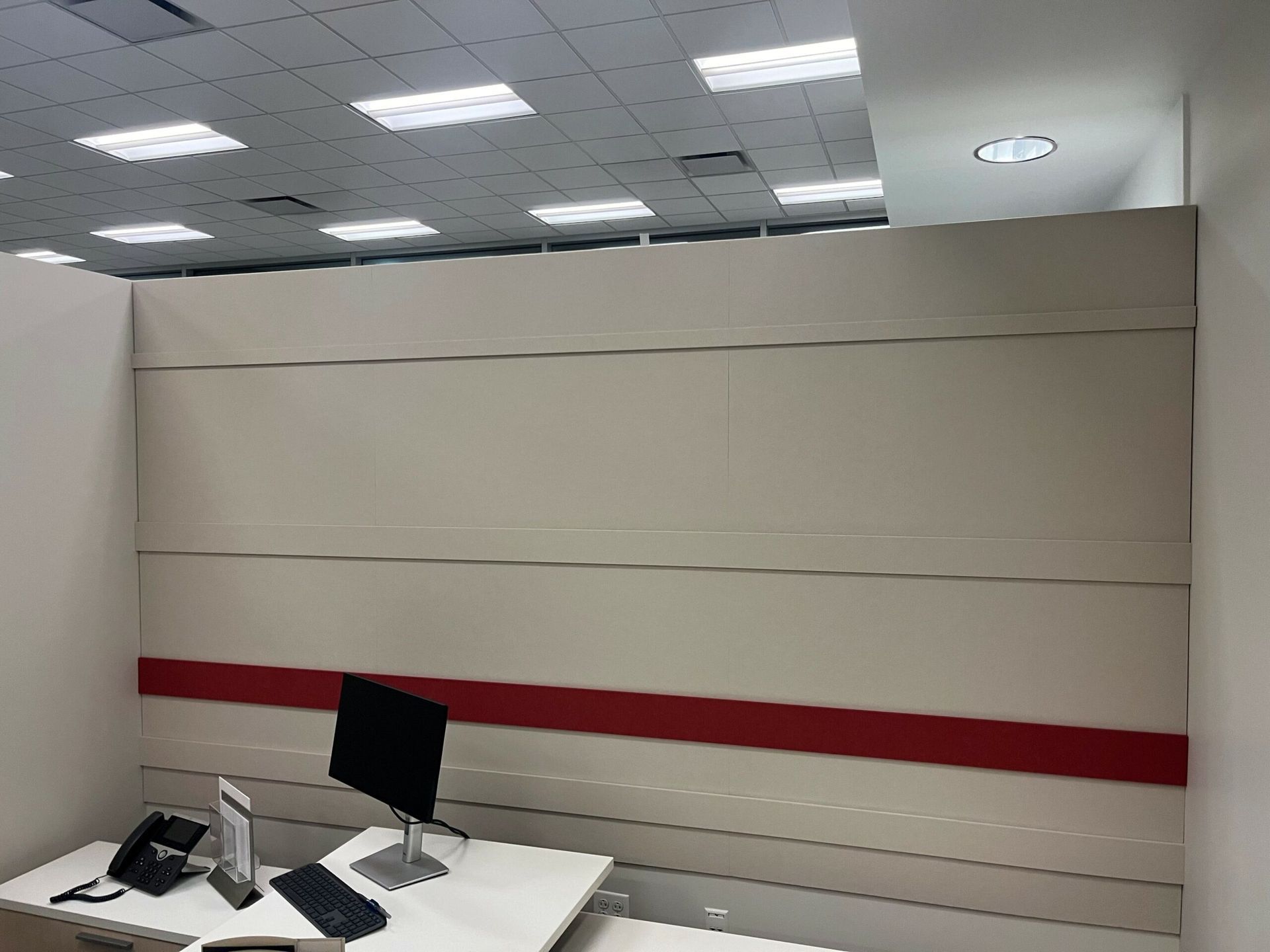 A white desk with a computer and a phone on it