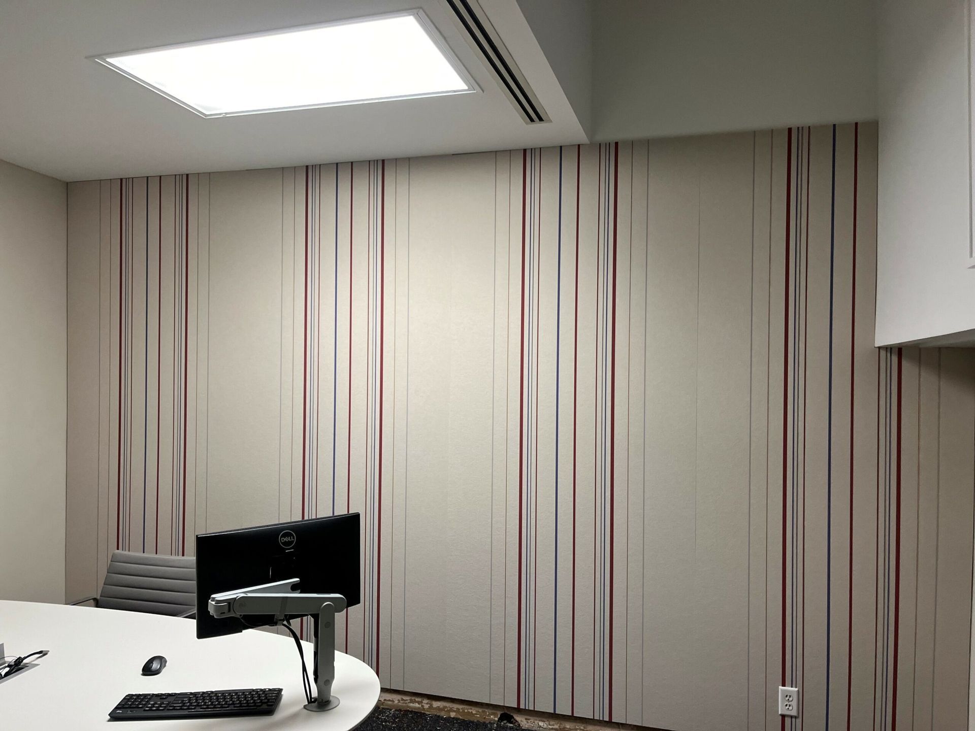 A conference room with a table and a computer on it.