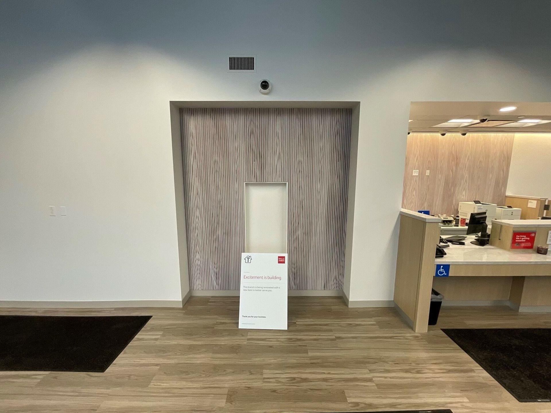 There is a sign in the middle of the room that says ' Excitement is building' on it.