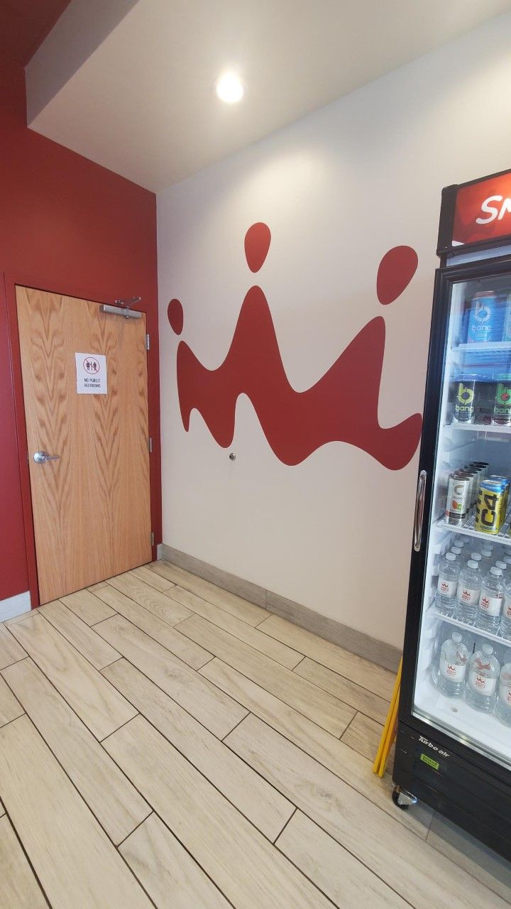 A room with a door and a fridge that says star on it