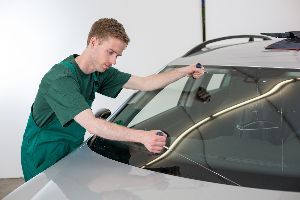 Mechanic inspecting windshield — Waipahu, HI — Westside Fender/Body & Refinishing