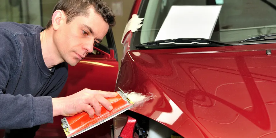 Mechanic repairing red car — Waipahu, HI — Westside Fender/Body & Refinishing