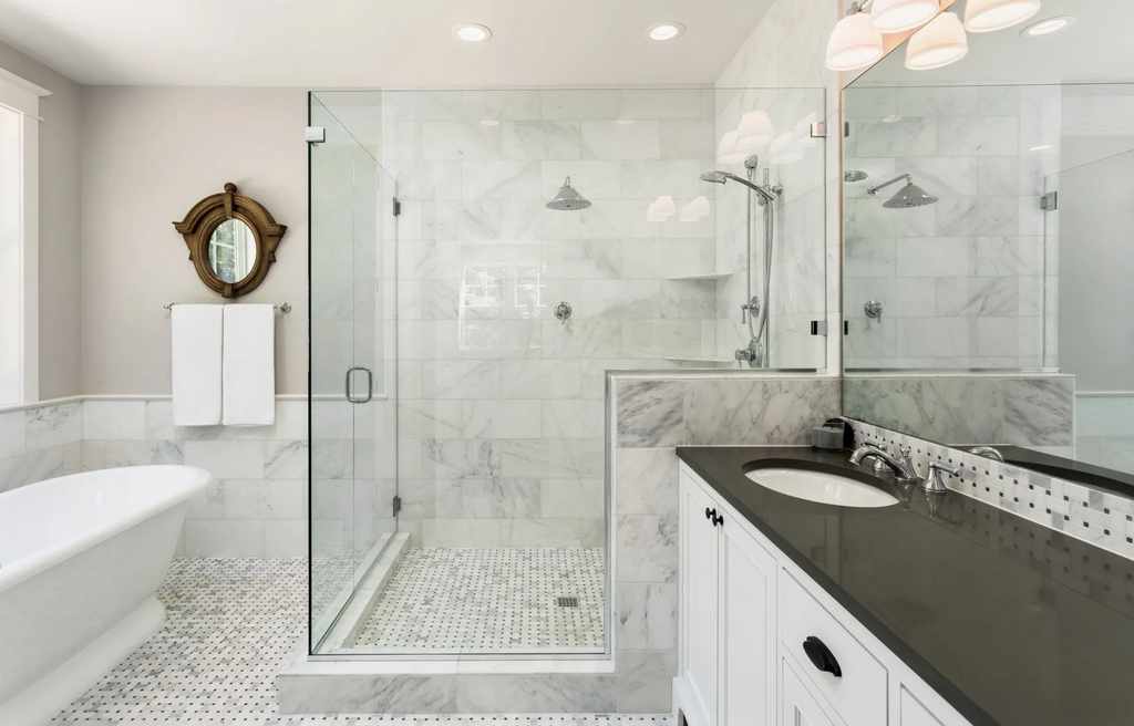 A bathroom with a walk in shower , sink , and mirror.