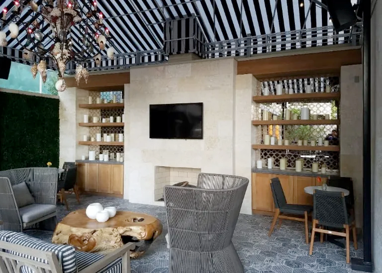 A living room with a striped ceiling and a flat screen tv