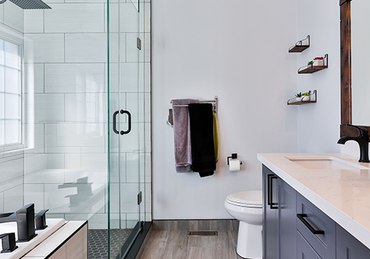 A bathroom with a toilet , sink , and shower.