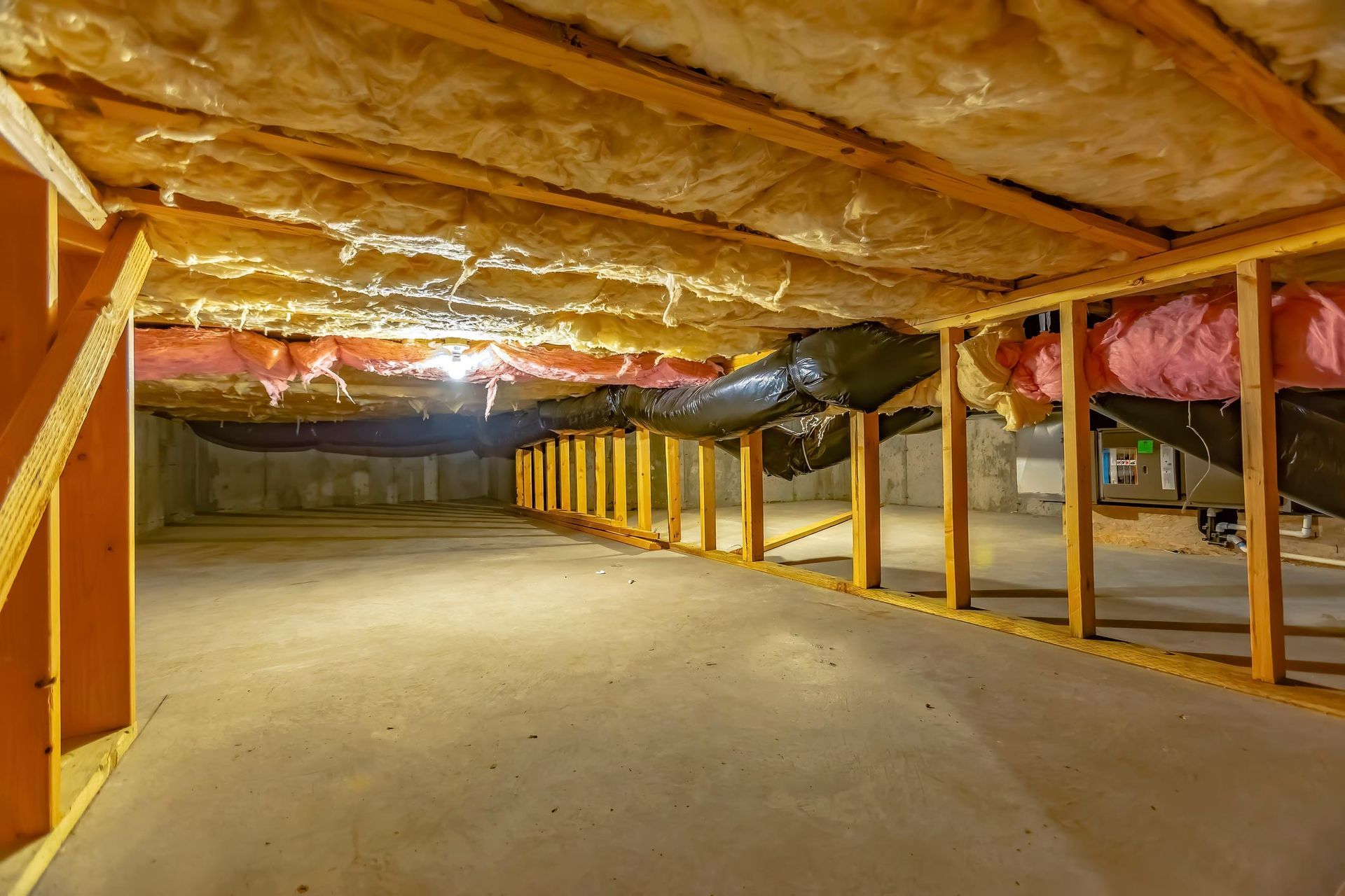 View of a crawl space with wooden beams, highlighting the need for crawl space clean-up in Everett