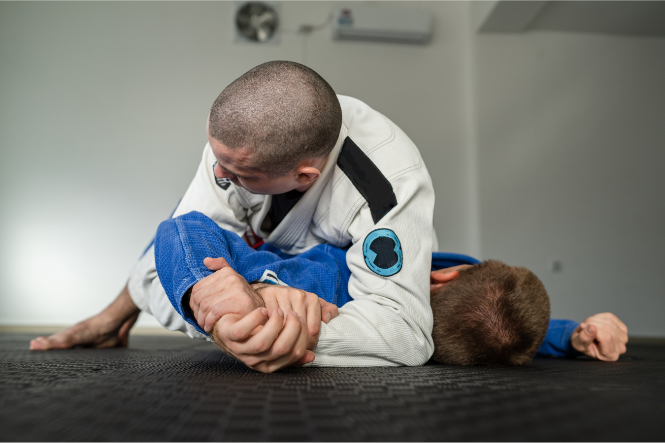 Adults training Jiu-Jitsu at Almighty Jiu-Jitsu in Huntington Beach, CA, practicing calm breathing.